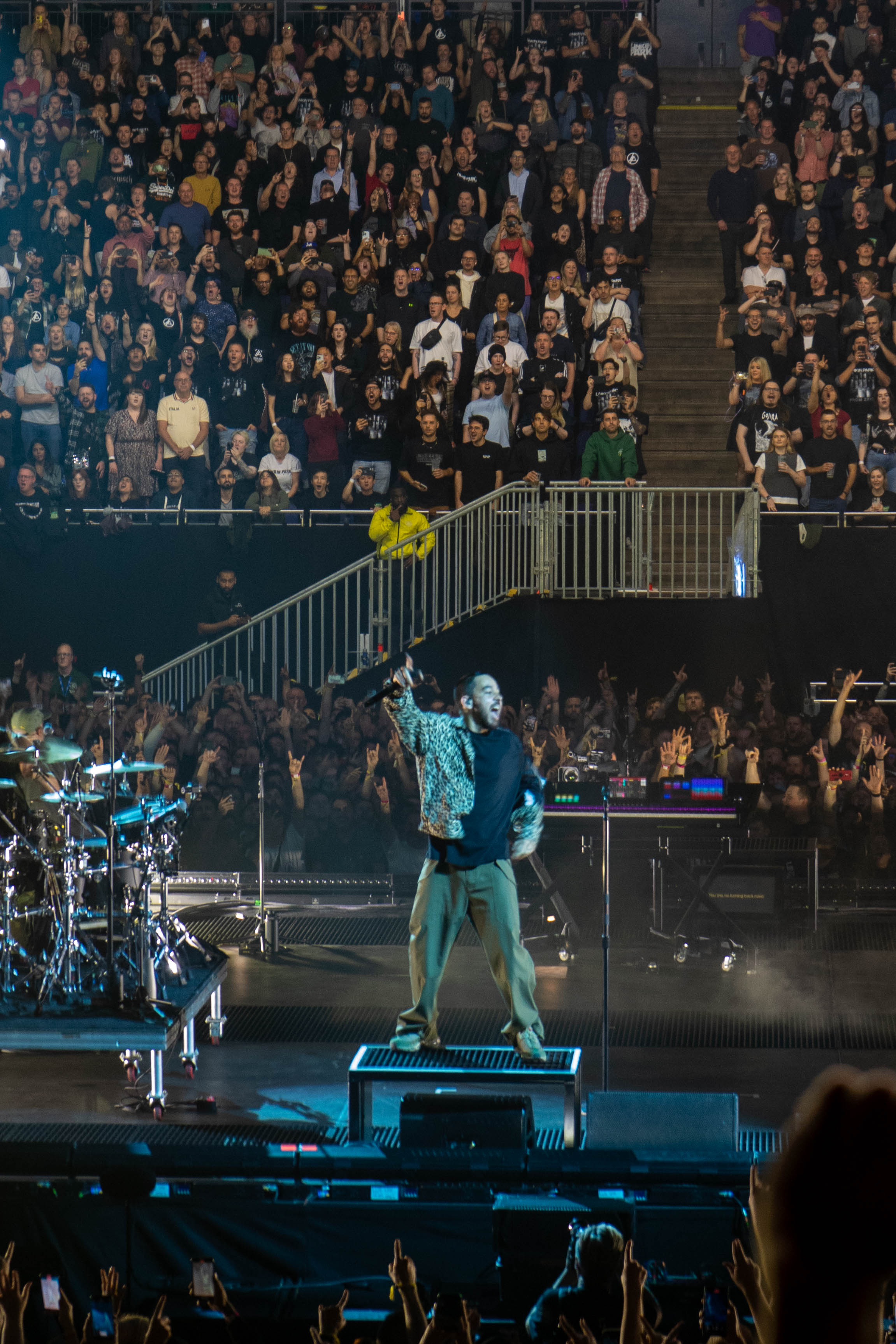 Mike Shinoda holding microphone against the sky